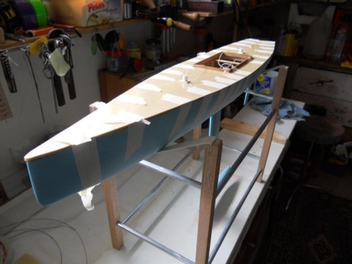 A model yacht part way through construction. Glueing the deck to the hull.