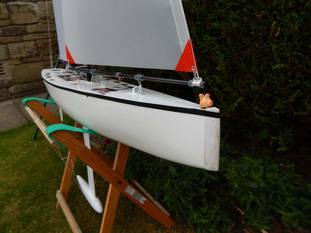 bow of a model yacht, sitting on the lawn. The boat is white, Location: United Kingdom